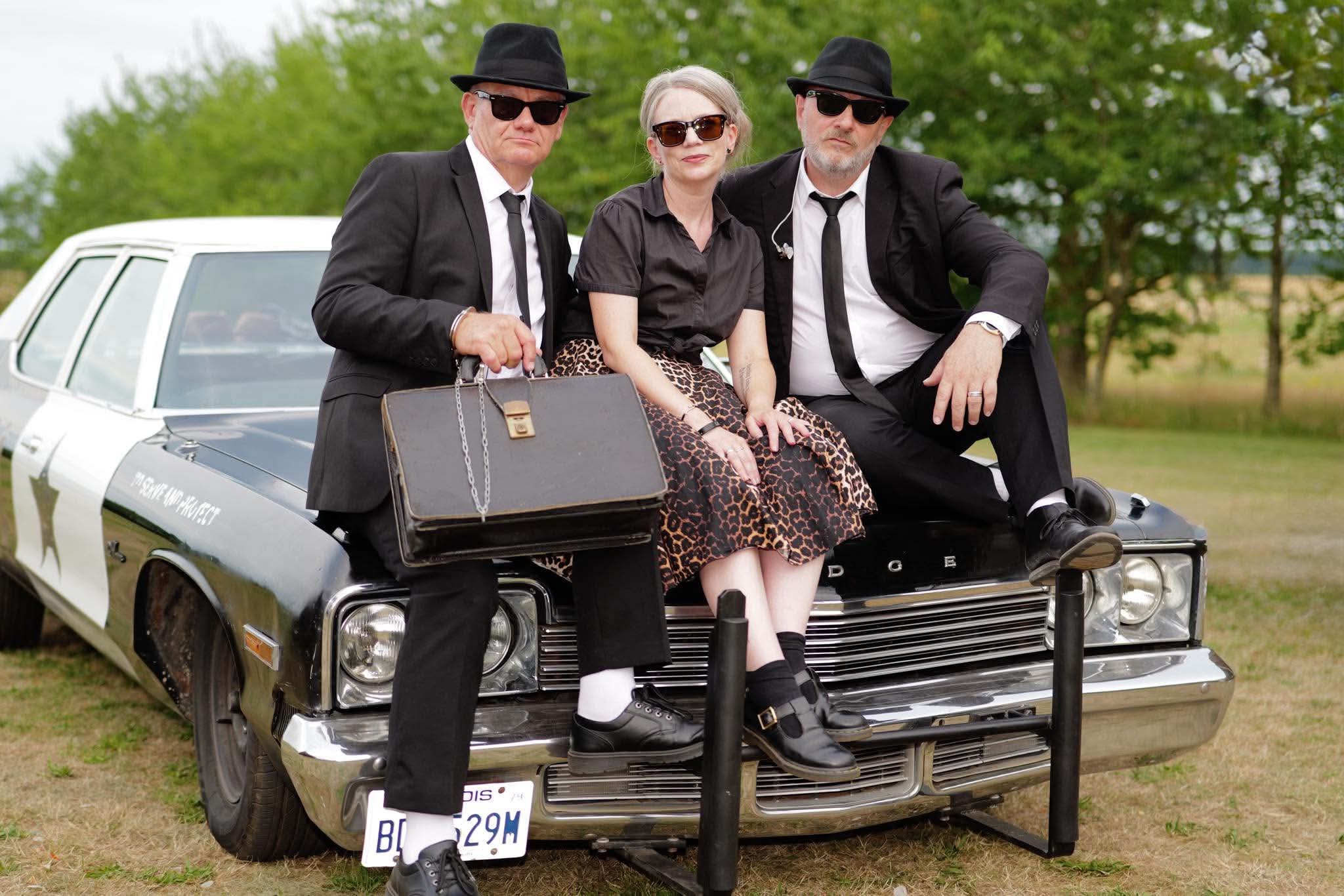 Jake, Elwood and a performer posing on the Bluesmobile